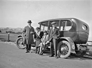 Roadside Prints: Four people relaxing by their car at the roadside