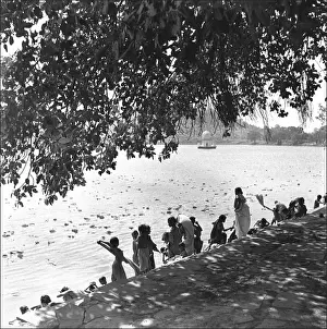 People on a riverbank, India