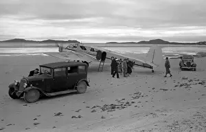 Spartan Prints: People on sandy beach with cars and light aircraft, Scotland