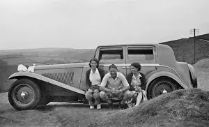 Wires Prints: Three people sitting on running board of car