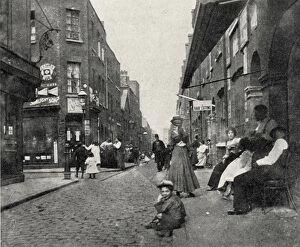 Cobble Stones Collection: People sitting on street, Whitechapel, East London