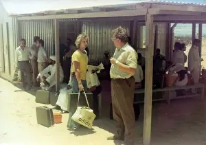People waiting with luggage in Oman