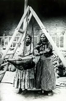 Images Dated 30th April 2021: Two Persian women rocking a goatskin to churn milk