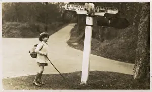 Signpost Prints: Petworth - Young boy checking his directions on a signpost