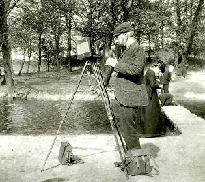 Photographer in a park with wooden camera on tripod