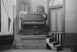 Iberia Prints: Piano on platform in auditorium, New Iberia, Louisiana