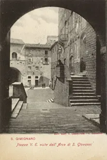 Piazza viewed through archway, San Gimignano, Tuscany, Italy