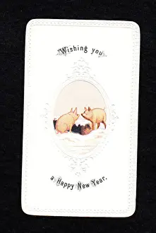 Two pigs in the snow on a New Year card