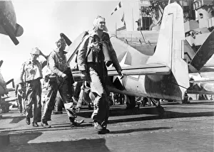 Hellcat Prints: Pilots walk past a Grumman F6F Hellcat on a carrier deck