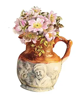 Pink flowers in a jug on a cutout Christmas card