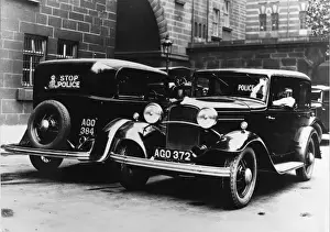 Head Lamps Prints: Police cars parked outside a station