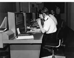 Police officers at work in communications room