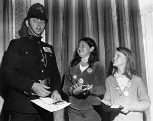 Policeman in 1920s uniform, with two girls