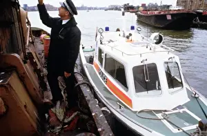 Policeman investigating a river barge