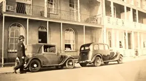 Policeman and parked late 1920s cars