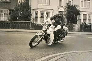 Goggles Collection: Policeman riding a Triumph motorcyle
