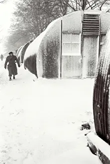 Helmsley Prints: Polish soldier walking outside Nissen Hut covered in snow