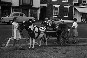 Pony giving a ride to children in his cart, Deal, Kent