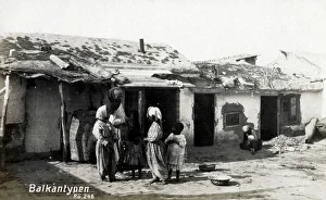 A poor Balkan Family outside their home