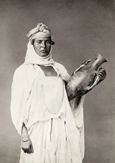 Portrait of a North African woman with a pot
