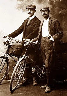 Portrait studio photo of cyclists, early 1900s