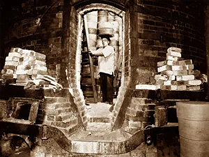 Pottery worker with a sagger, Potteries