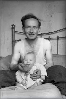 Vest Prints: Proud Father sitting in bed with his young baby