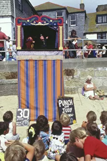 Watching Gallery: Punch and Judy show on the beach, Cornwall