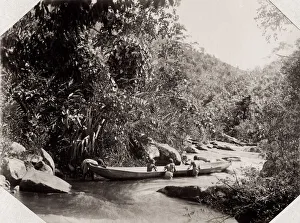 Pushing a canoe through a river cataract, Madagascar