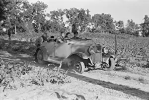 Laborer Prints: Pushing a car belonging to agricultural day laborer to start