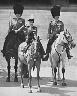 The Queen salutes on horseback