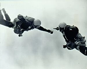 Diver Collection: RAF parachutists pouring beer while in freefall. Date: 1960s