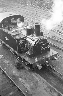 Railway engineer working on steam train, Liverpool Street St