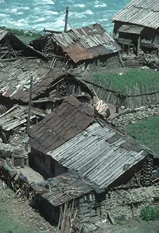 Jammu Prints: Ramshackle wooden houses alongside the river in Sind Valley