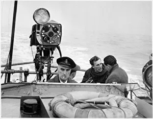 Raymond Baxter filming at sea, on location