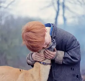 Red-haired gipsy boy with a dog