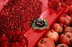 Red pomegranate seeds on display - market stall in Old Delhi Red pomegranate seeds on display - market stall in Old Delhi