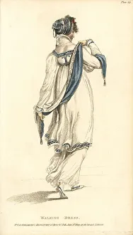 Regency womanin walking dress fixing her scarf