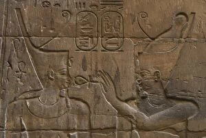 Ansata Gallery: Relief depicting Egyptian divinity giving the Ankh to a phar