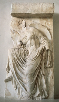 Relief depicting Nike or Victory tie his sandals. Bastion of Relief depicting Nike or Victory tie his sandals. Bastion of