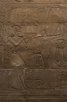 Relief depicting a pharaoh making offerings to the god MIN