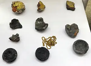 Remains of vitreous mass, clays crucible and pearls. 13th c