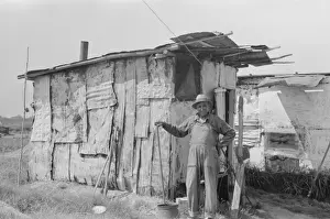 Shacks Prints: Resident of Tin Town on river side of levee, Caruthersville