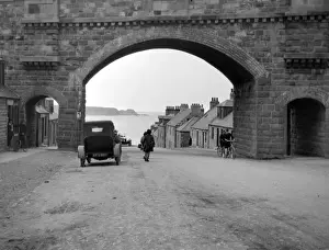 Roadway Prints: Road with arched bridge leading to the sea