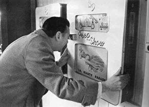Viscount Gallery: Robin Maugham looking at a peep-show in Brighton
