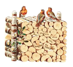 Firewood Prints: Robins perched on a pile of logs on a cutout New Year card