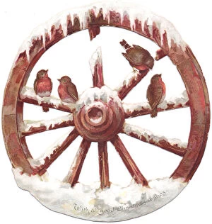 Images Dated 3rd December 2015: Robins perched on a wheel on a cutout Christmas card