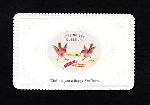 Two robins pulling crackers on a New Year card