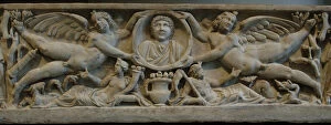Roman Art. Marble sarcophagus with flying erotes holding a c