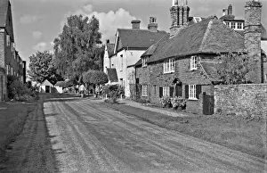 Verge Prints: A row of picturesque cottages in a lane